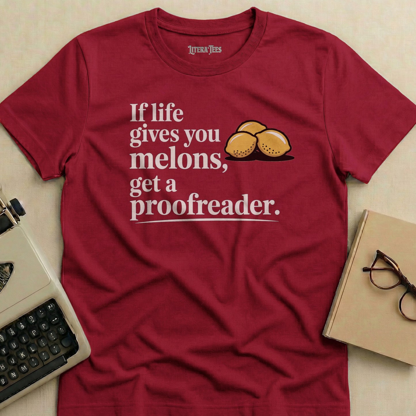 Maroon t-shirt with "If life gives you melons, get a proofreader" and three lemons.
