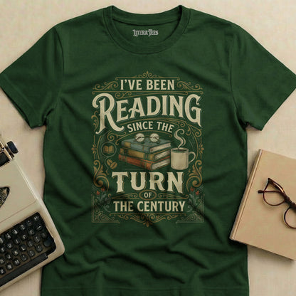 Green t-shirt with "I've Been Reading Since the Turn of the Century" text and books.