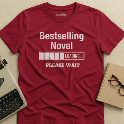 Maroon t-shirt with "Bestselling Novel Loading Please Wait" text.