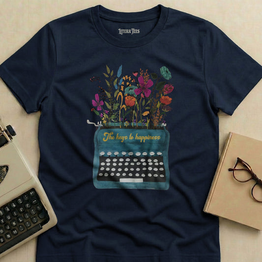 Navy t-shirt with turquoise typewriter and floral illustration, "The keys to happiness" text.