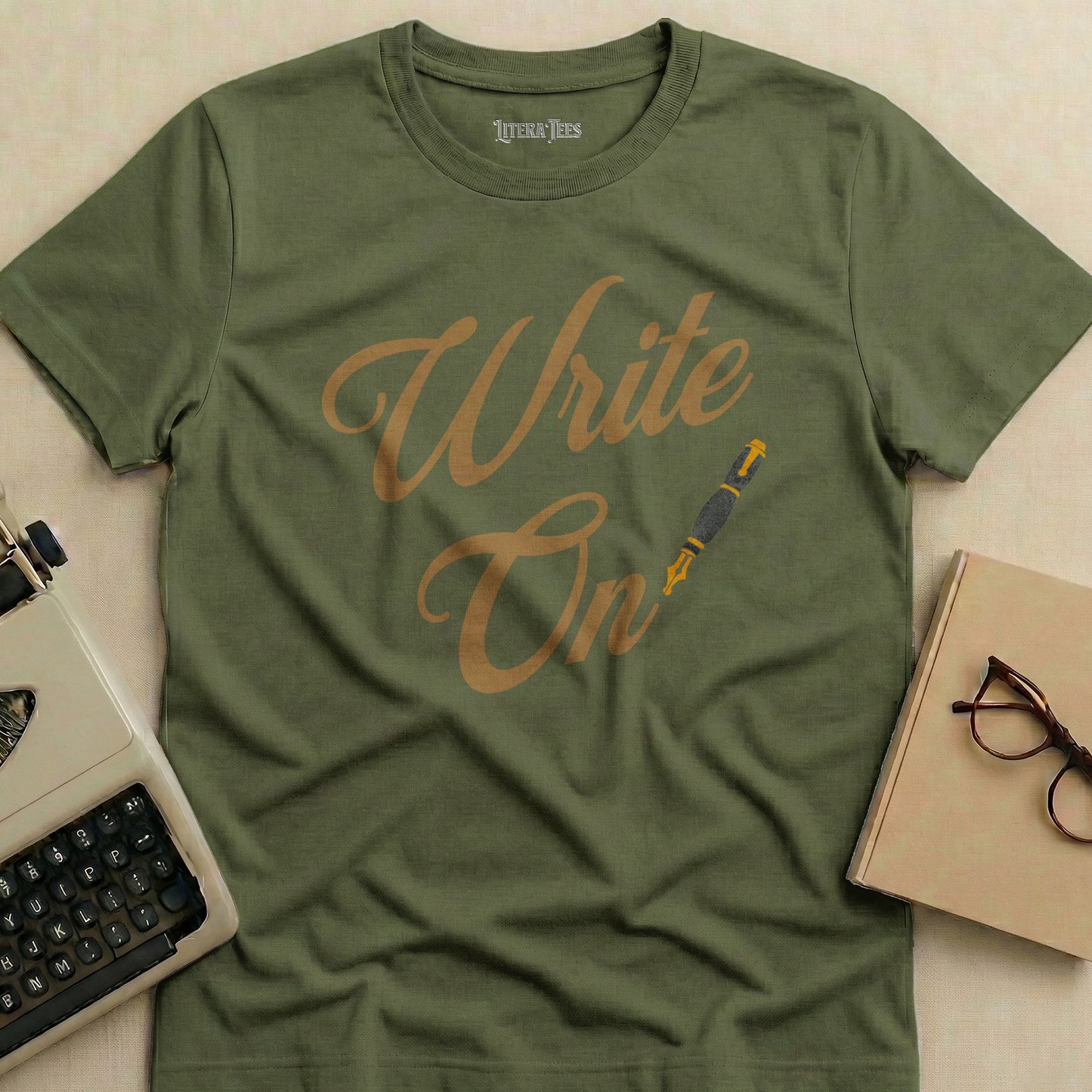 Olive green t-shirt with "Write On" and a fountain pen graphic.