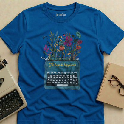 Blue t-shirt with vintage typewriter and flowers, reading "The keys to happiness."