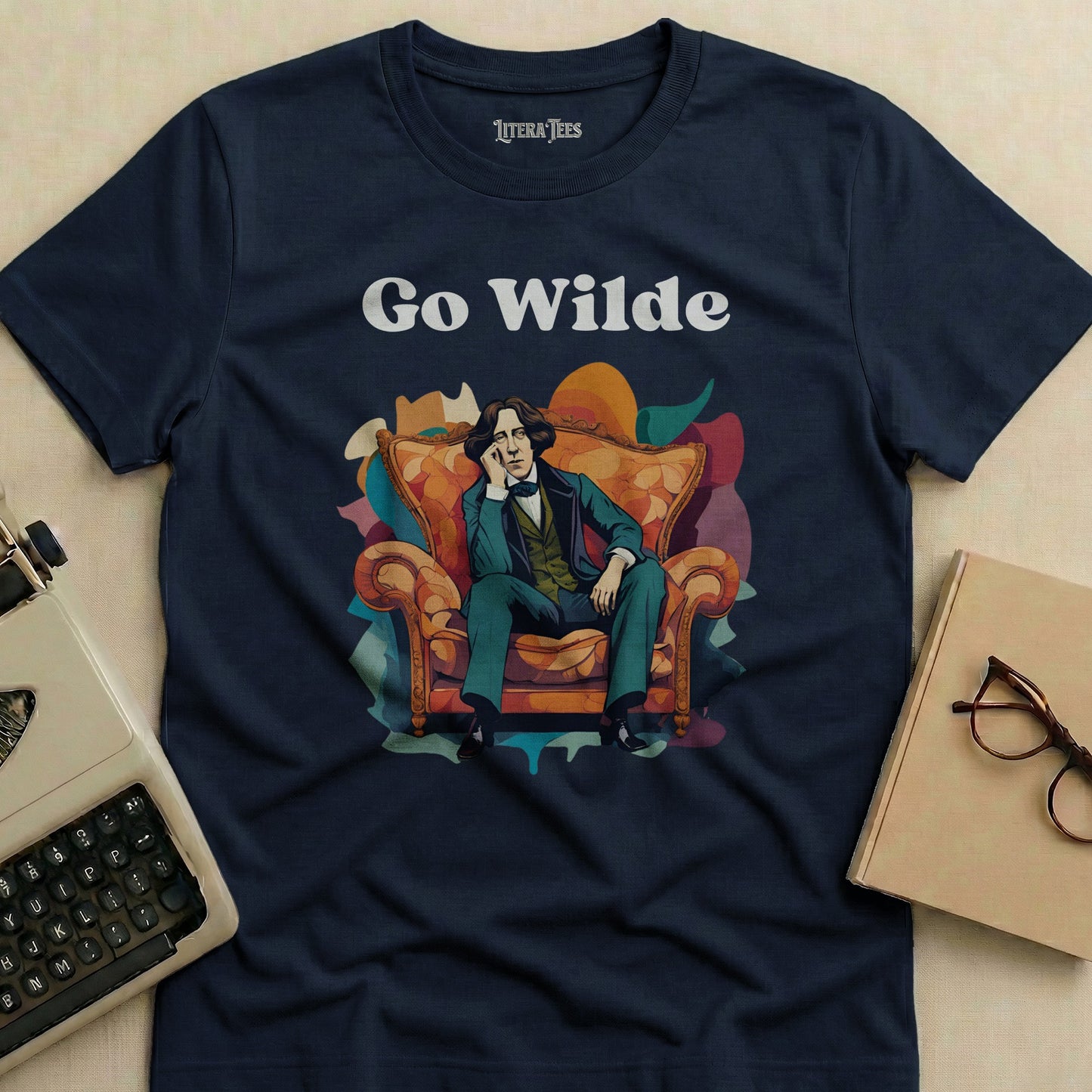Navy t-shirt with "Go Wilde" and a seated man in a colorful, abstract background.