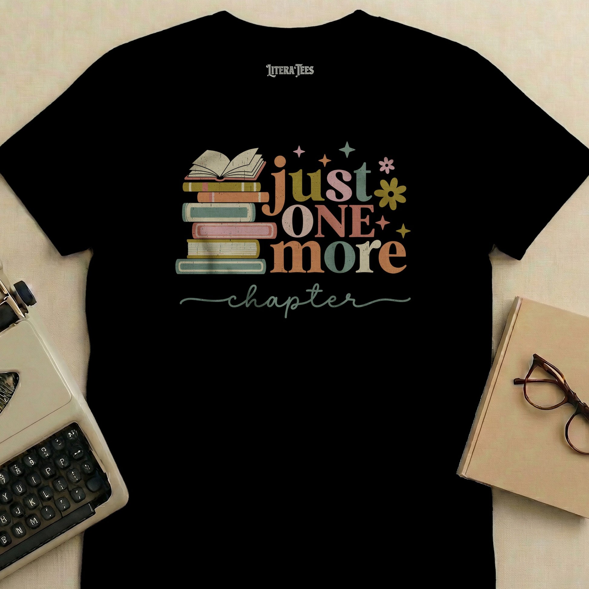 T-shirt with stacked books and text "just ONE more chapter".