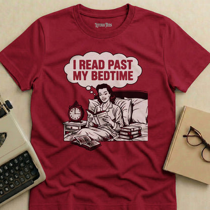 Maroon t-shirt with graphic of woman reading in bed, text "I READ PAST MY BEDTIME".