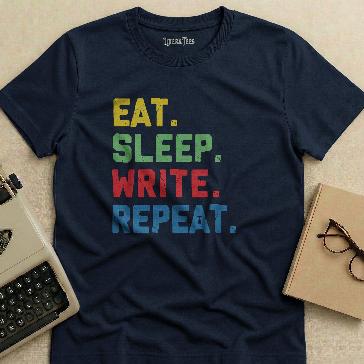 Navy t-shirt with "EAT. SLEEP. WRITE. REPEAT." text.