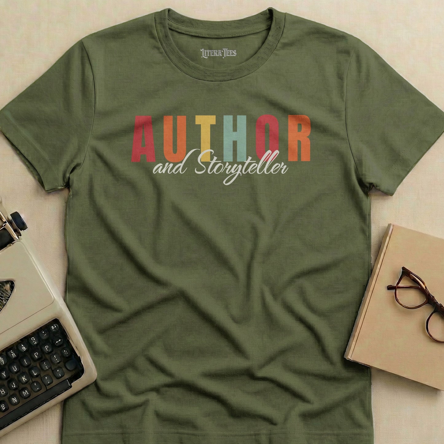Olive green t-shirt with "Author and Storyteller" text in colorful block letters.