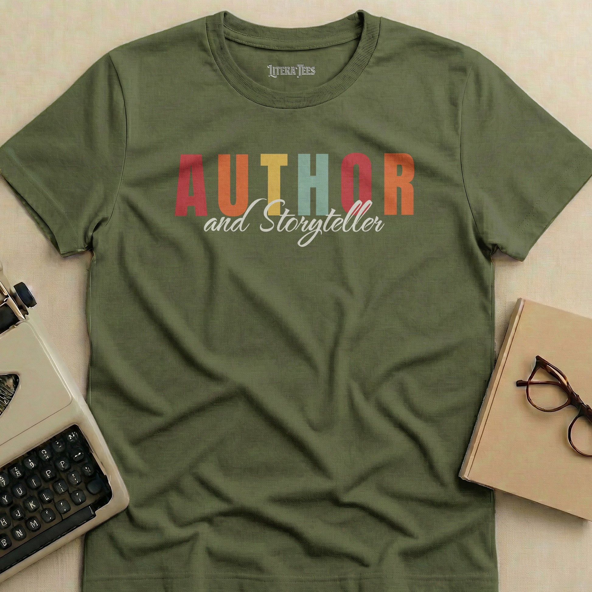 Olive green t-shirt with "Author and Storyteller" text in colorful block letters.