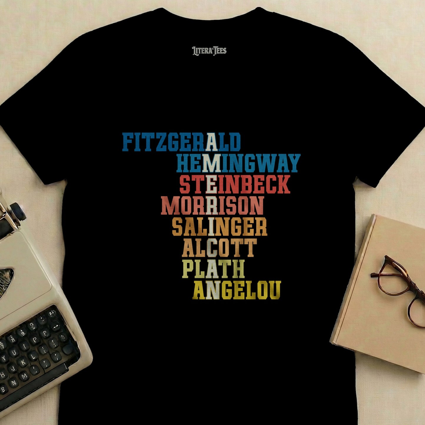 Black t-shirt with names of famous authors in colored block lettering.