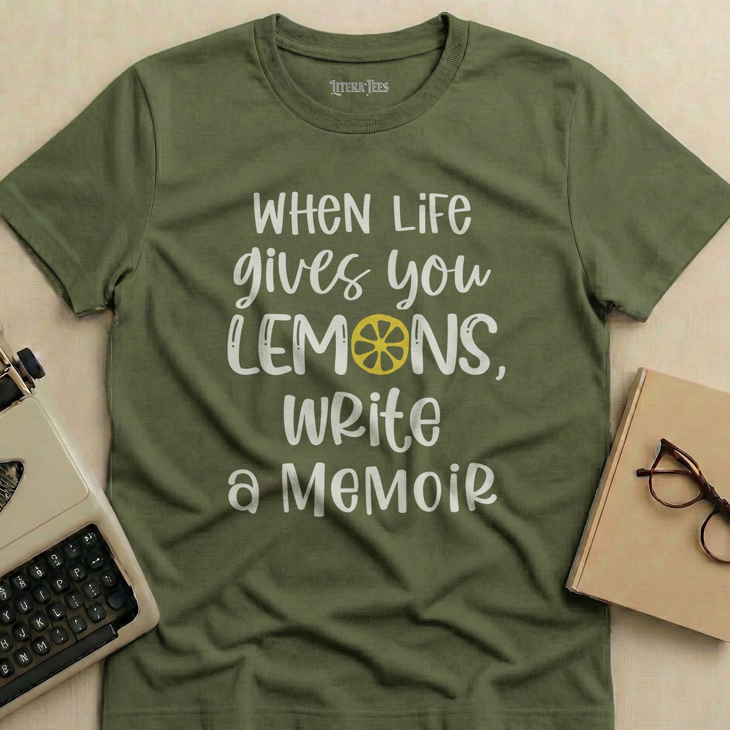 Olive green t-shirt with "When Life gives you LEMONS, Write a Memoir" text.