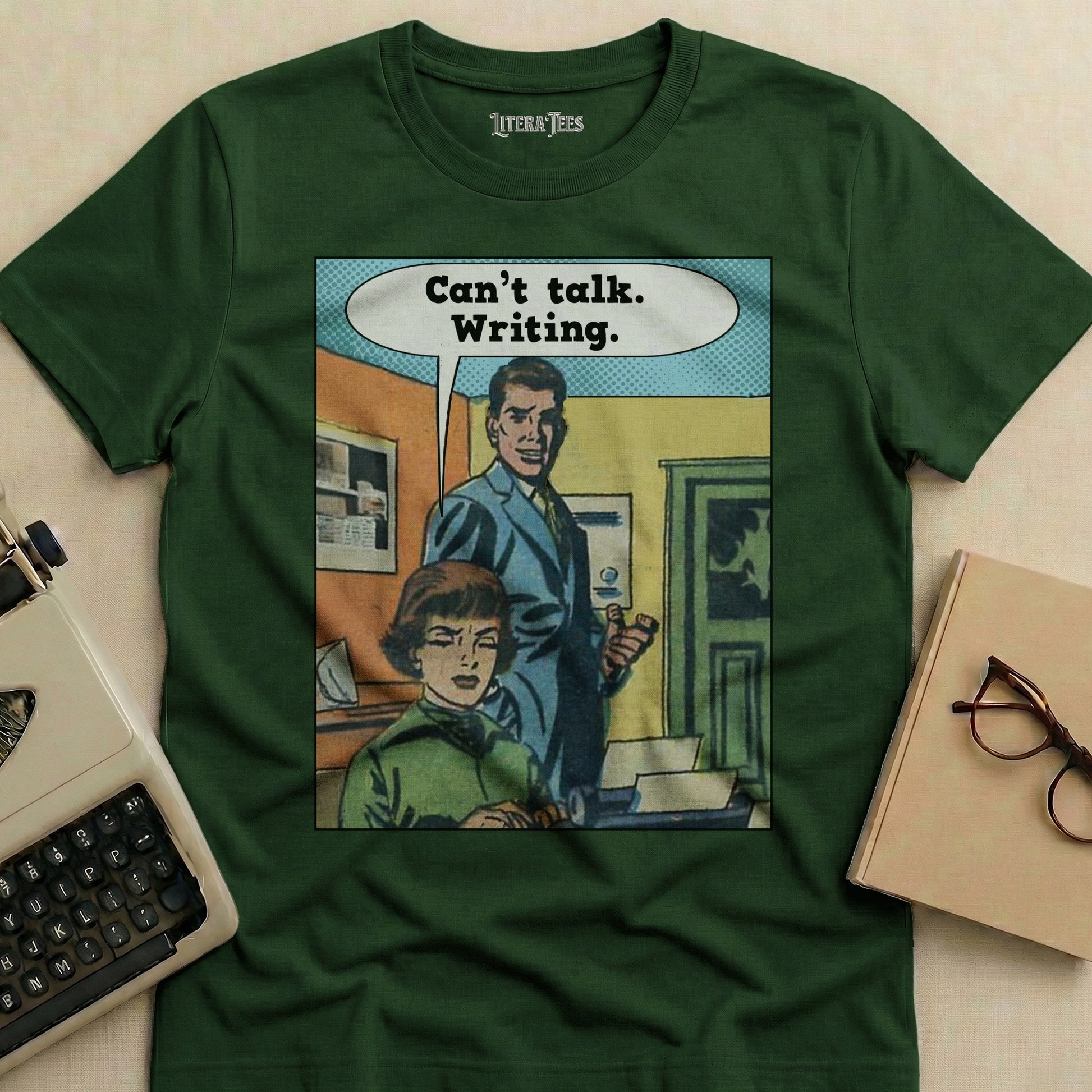 Green t-shirt with "Can't talk. Writing." comic graphic.