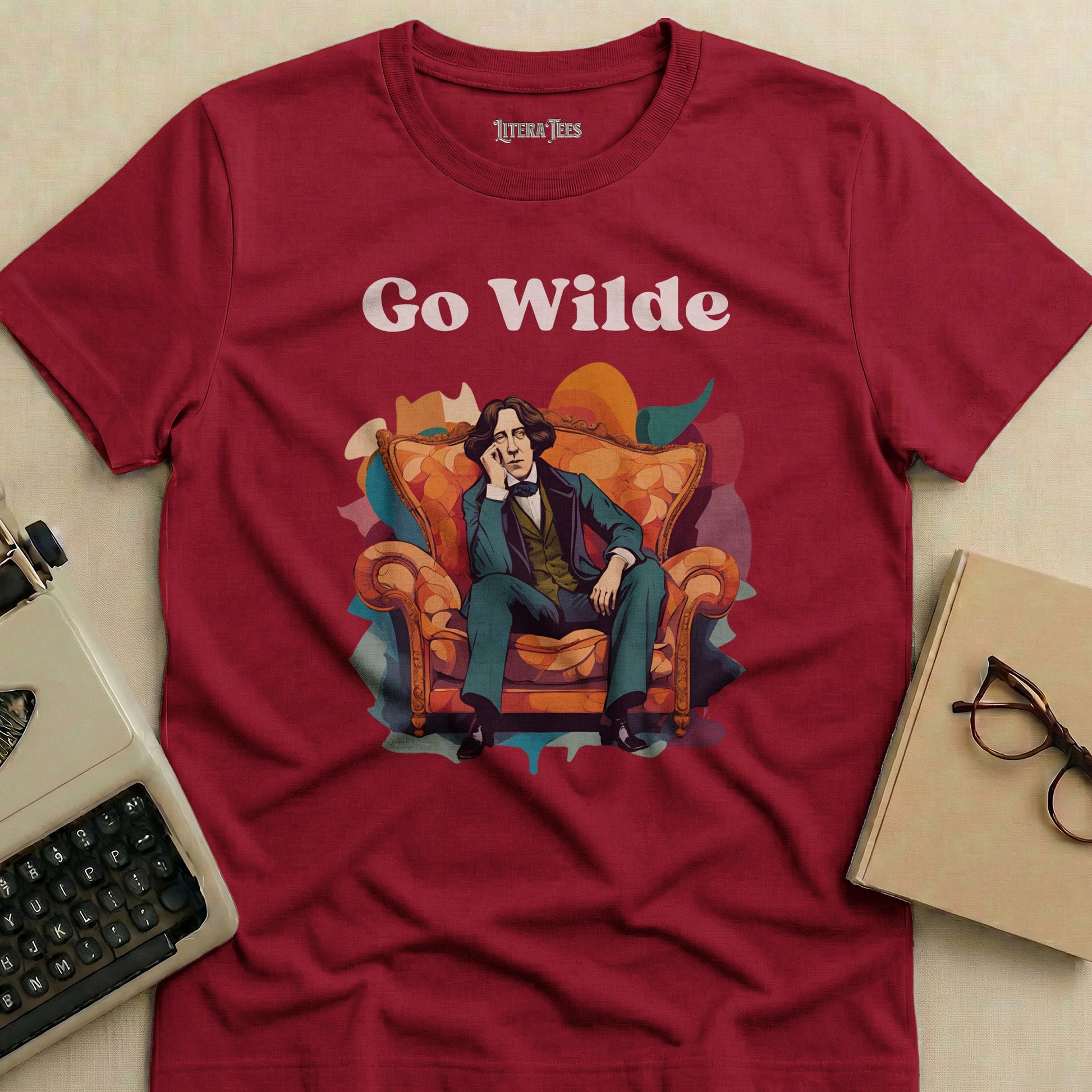 Maroon t-shirt with "Go Wilde" text and illustration of a man in a chair.