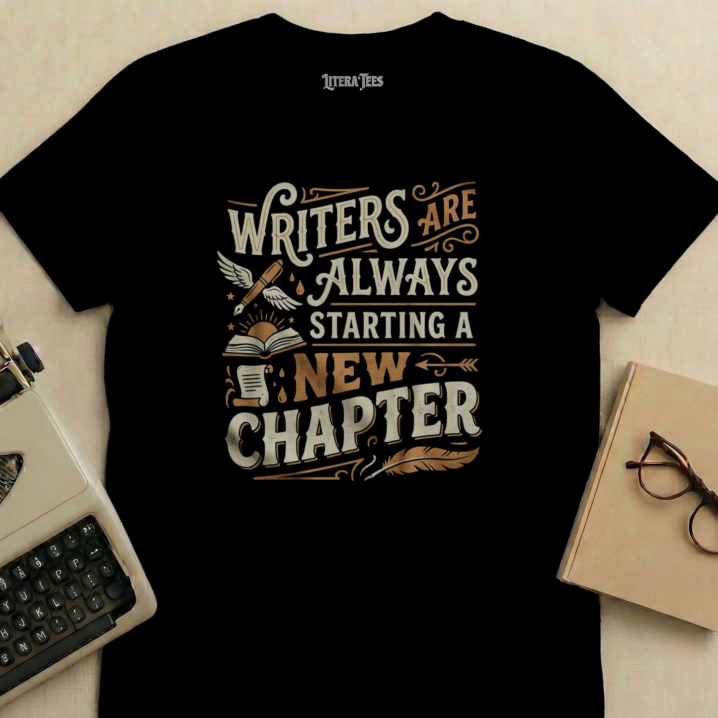 Black t-shirt with "Writers are always starting a new chapter" text.