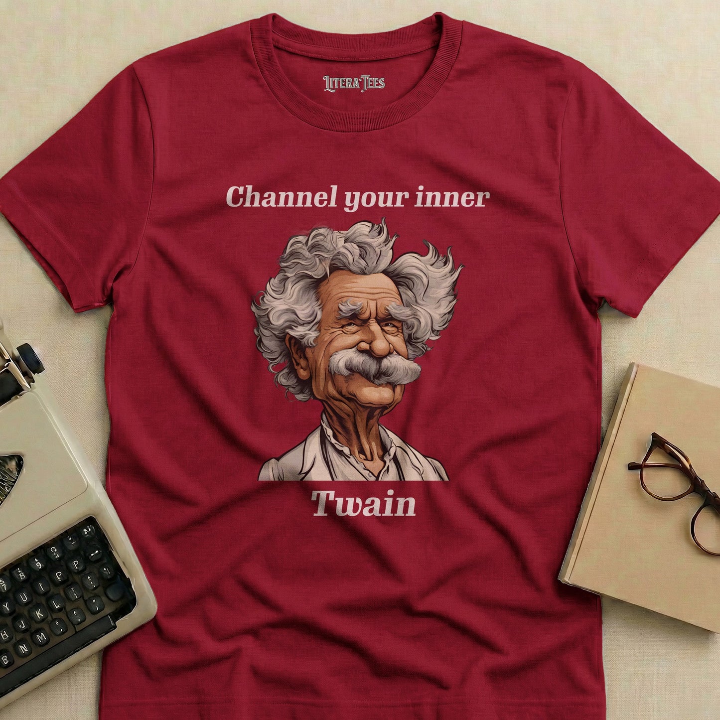 Maroon t-shirt with a caricature of Mark Twain and the text "Channel your inner Twain".