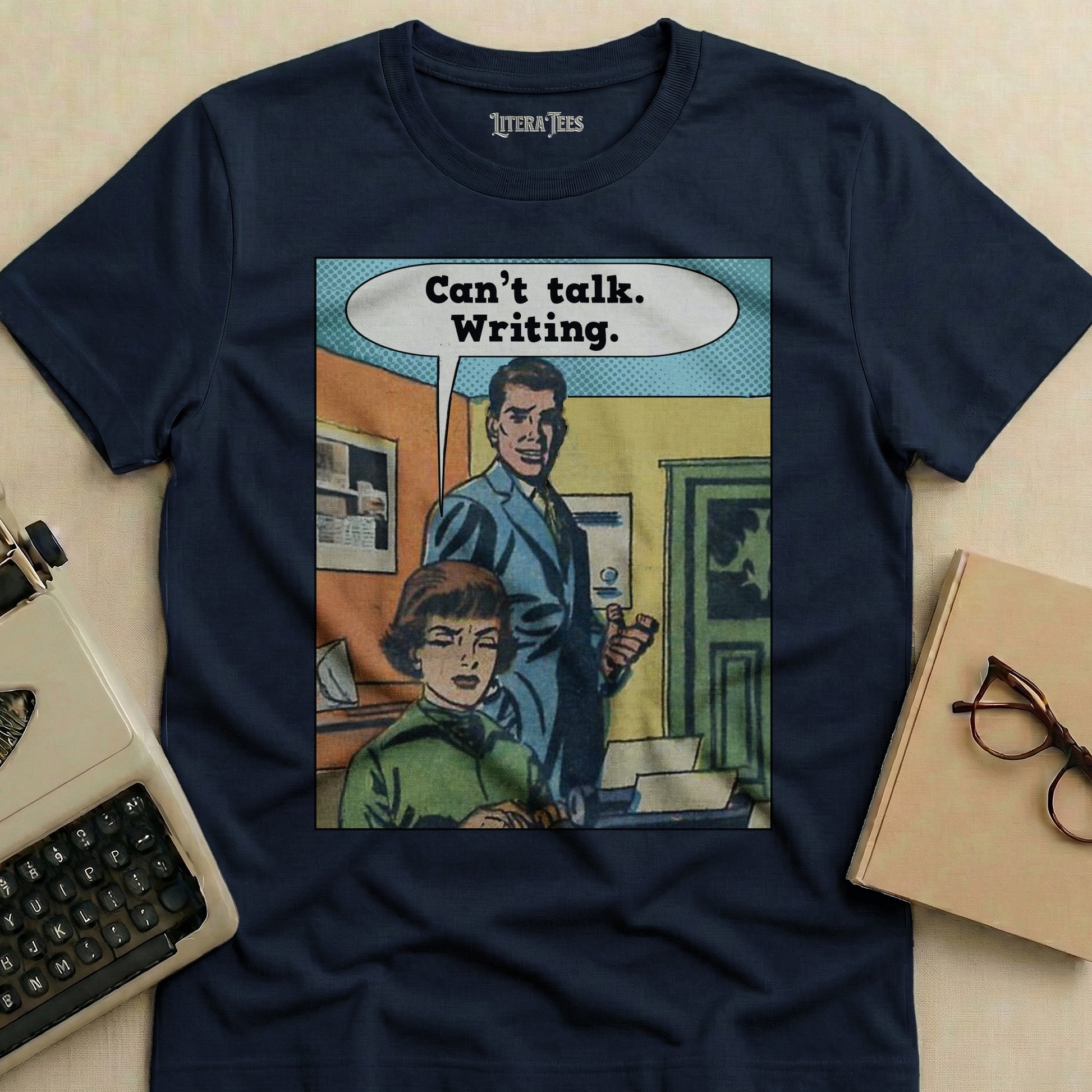 Navy t-shirt with comic strip art and "Can't talk. Writing." text.