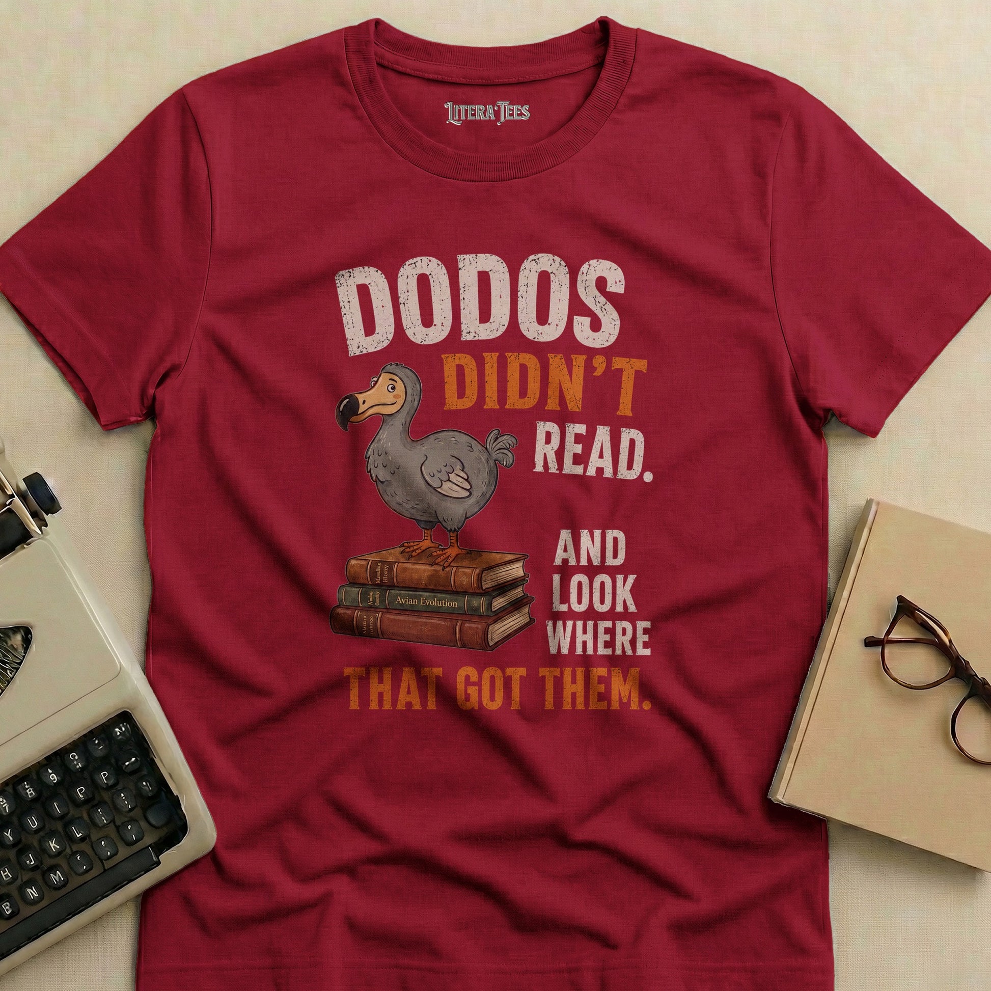 Maroon t-shirt with "Dodos Didn't Read. And Look Where That Got Them." text and dodo bird.