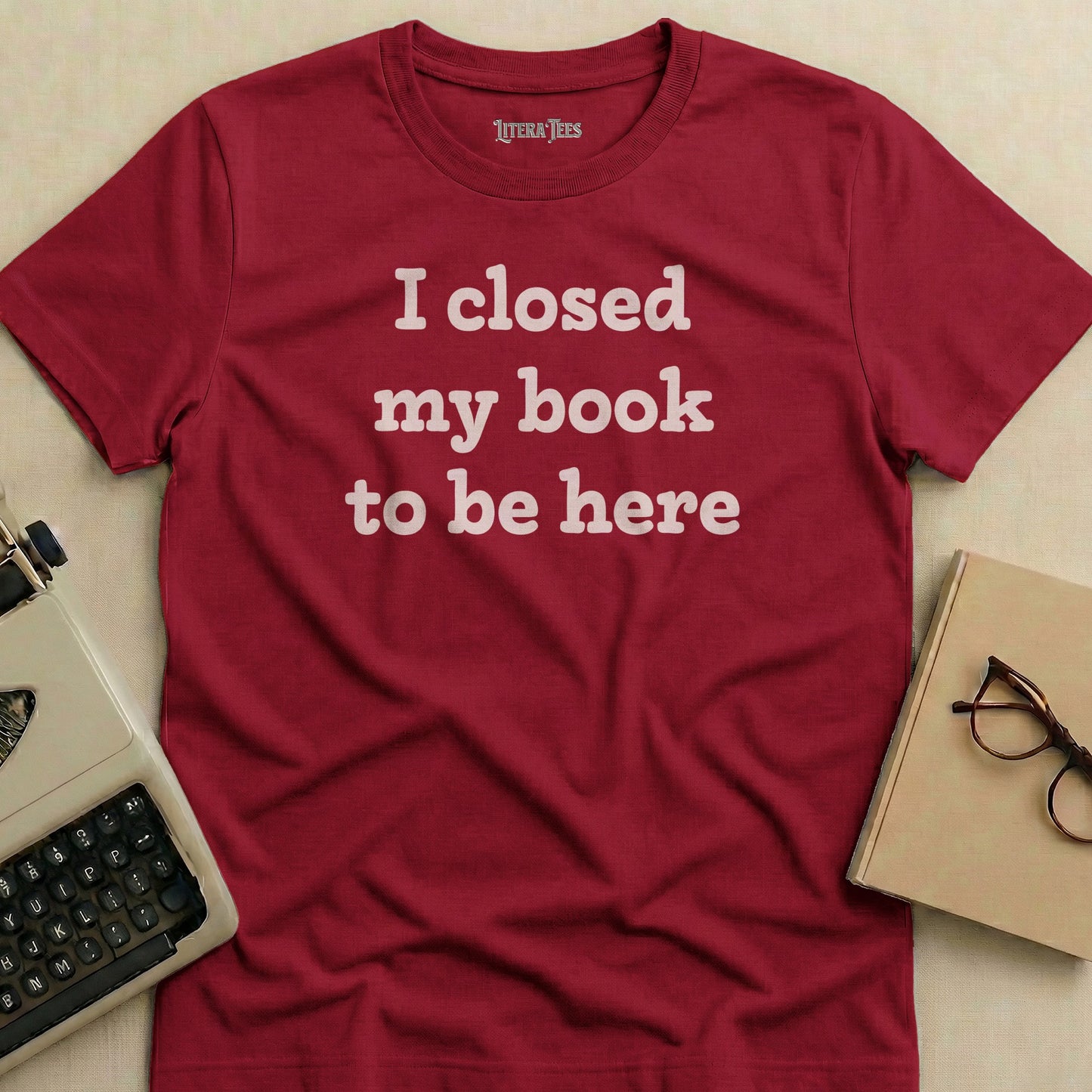 Maroon t-shirt with "I closed my book to be here" text.