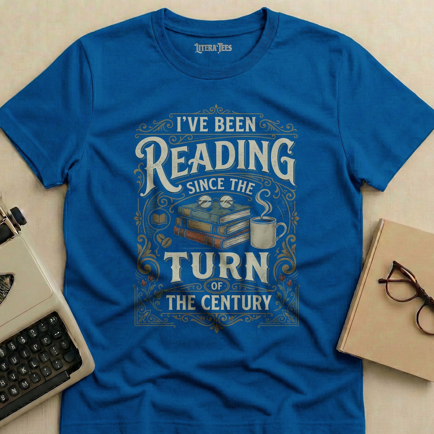 Blue t-shirt with "I've Been Reading Since The Turn of The Century" text and graphics.