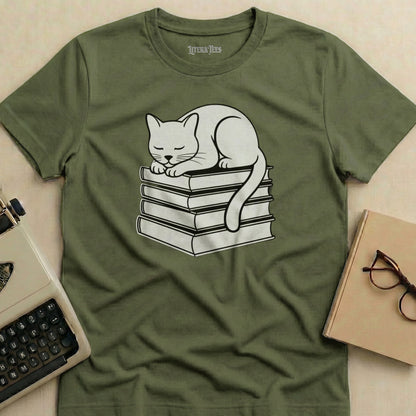 White cat sleeping on a stack of books.