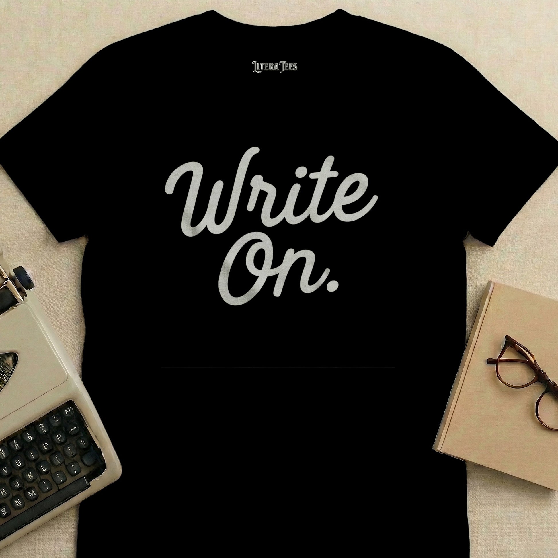 Black t-shirt with "Write On." text, typewriter and book.