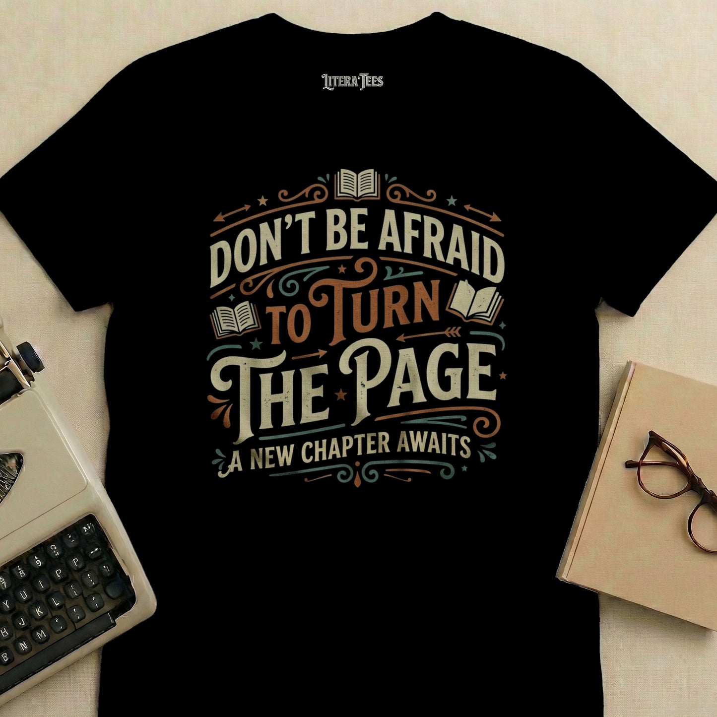 Black t-shirt with "Don't Be Afraid To Turn The Page, A New Chapter Awaits" text.