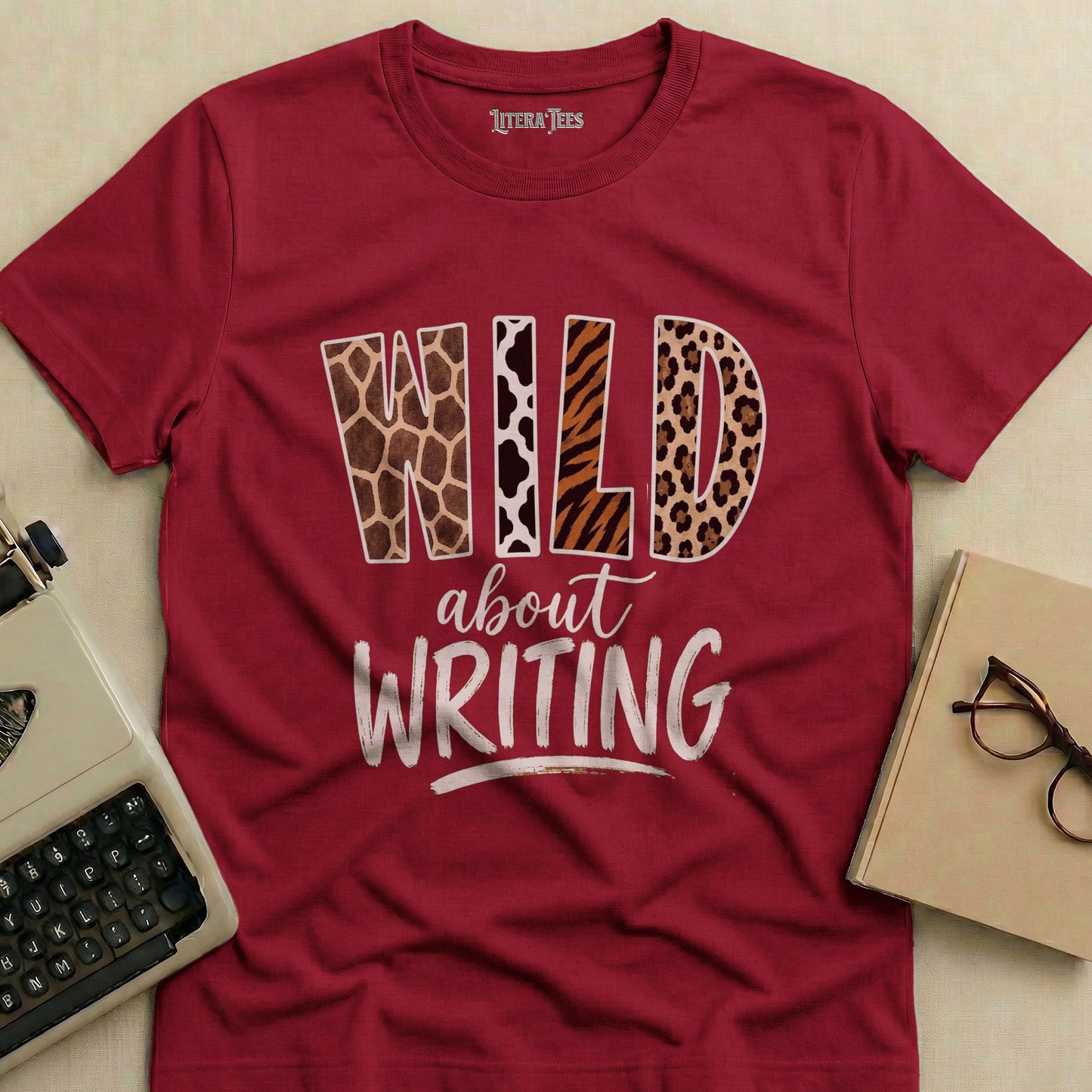 Maroon t-shirt with "WILD about WRITING" text and animal print patterns.