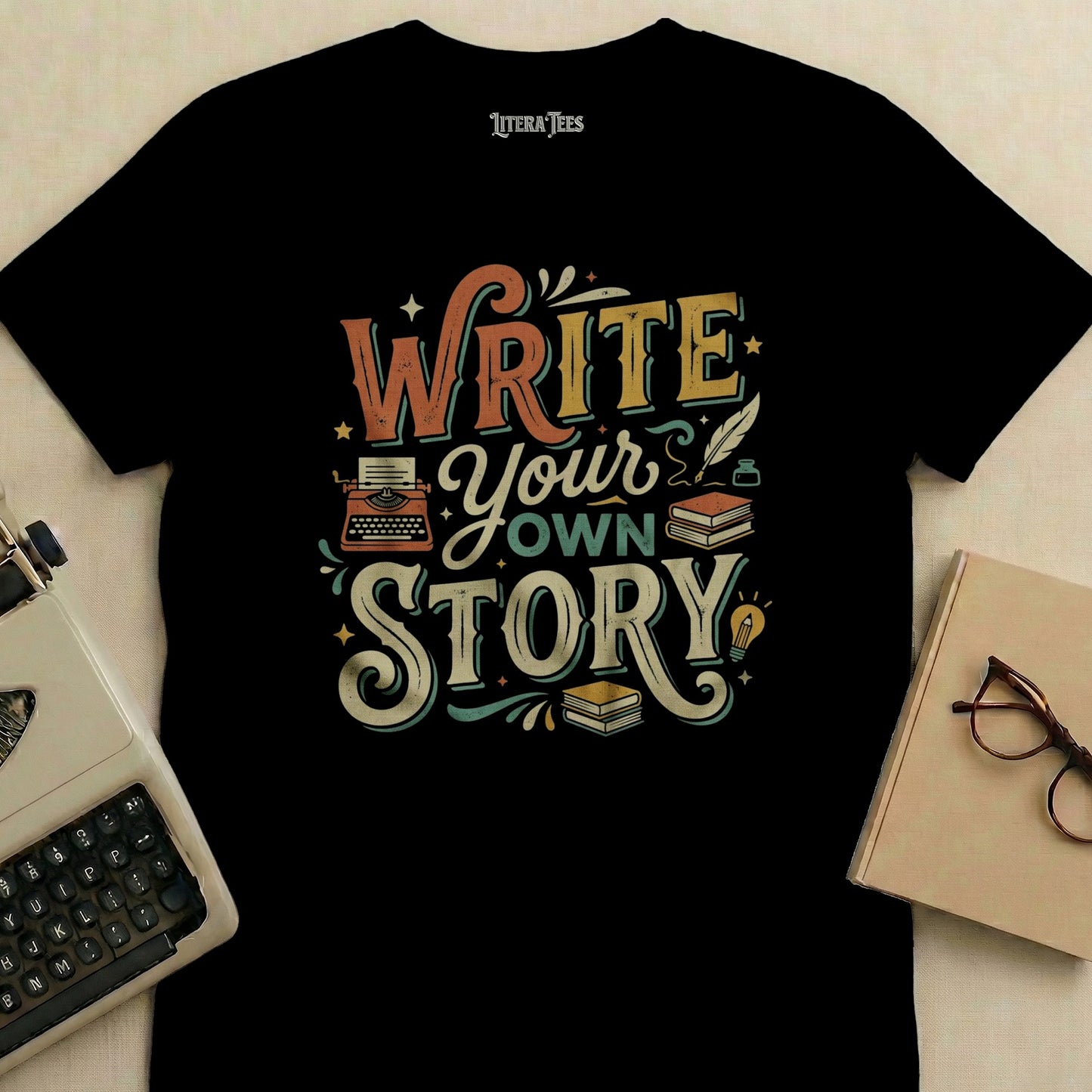 Black t-shirt with "Write Your Own Story" text and vintage typewriter graphic.