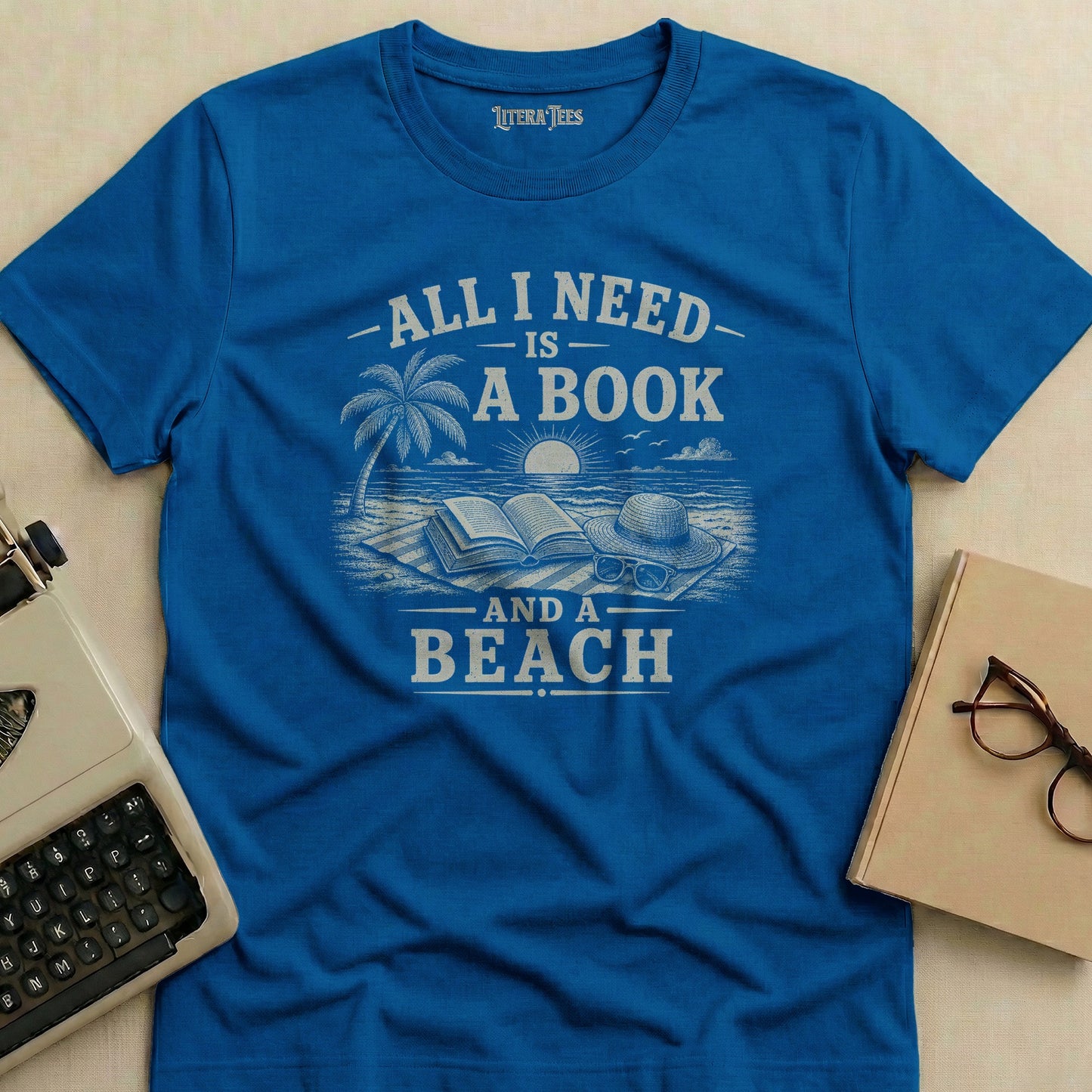 Blue t-shirt with "All I Need is a Book and a Beach" text and beach graphic.