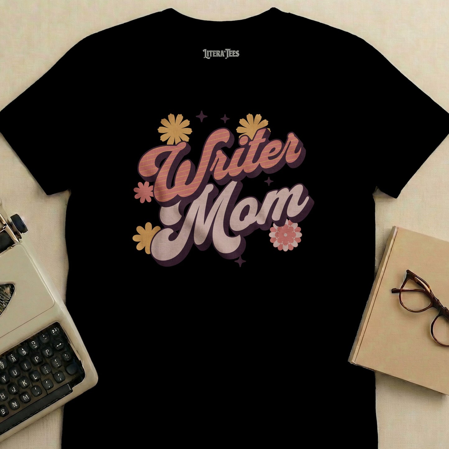 Black t-shirt with "Writer Mom" in retro script and floral design.