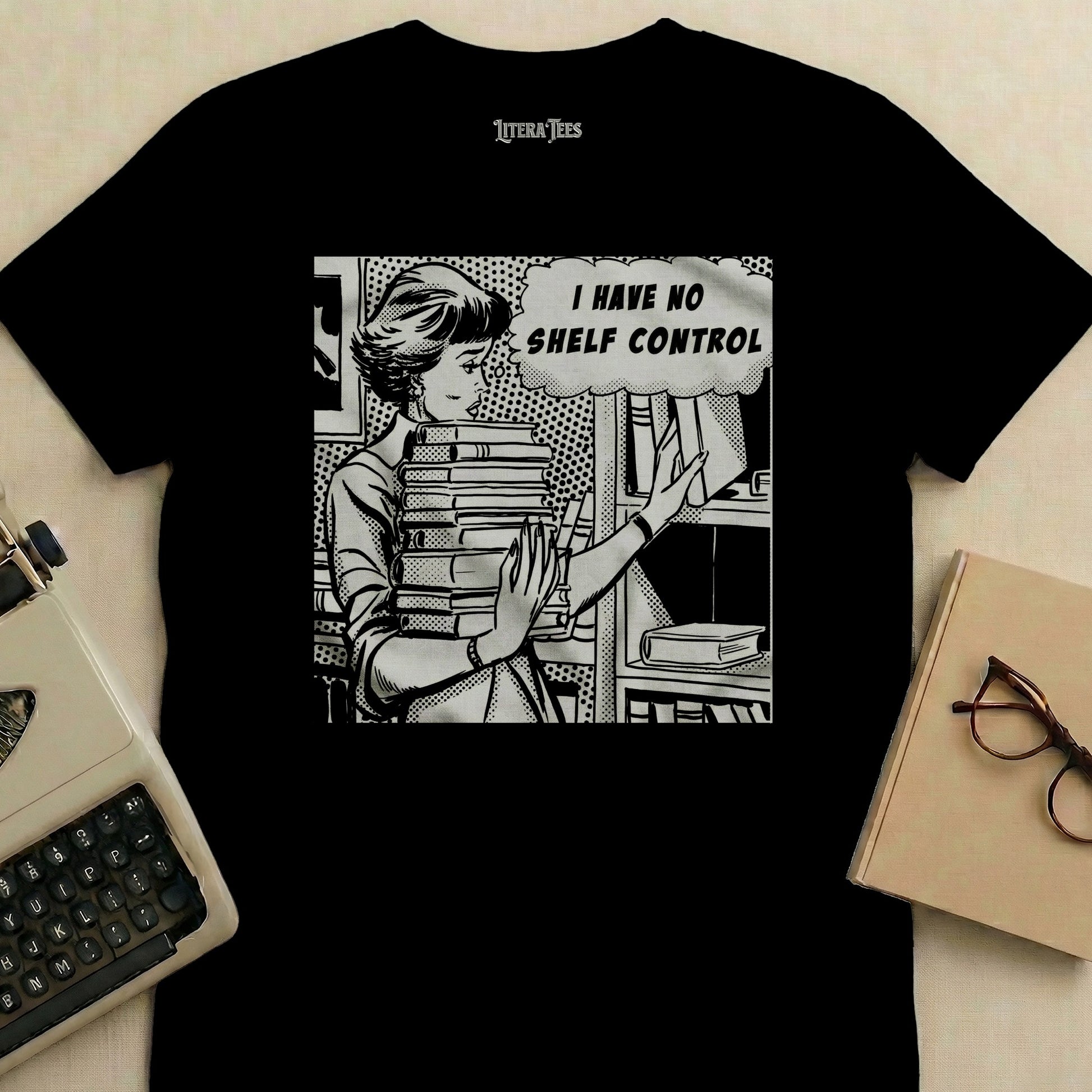 T-shirt graphic of woman with stack of books and text "I HAVE NO SHELF CONTROL".
