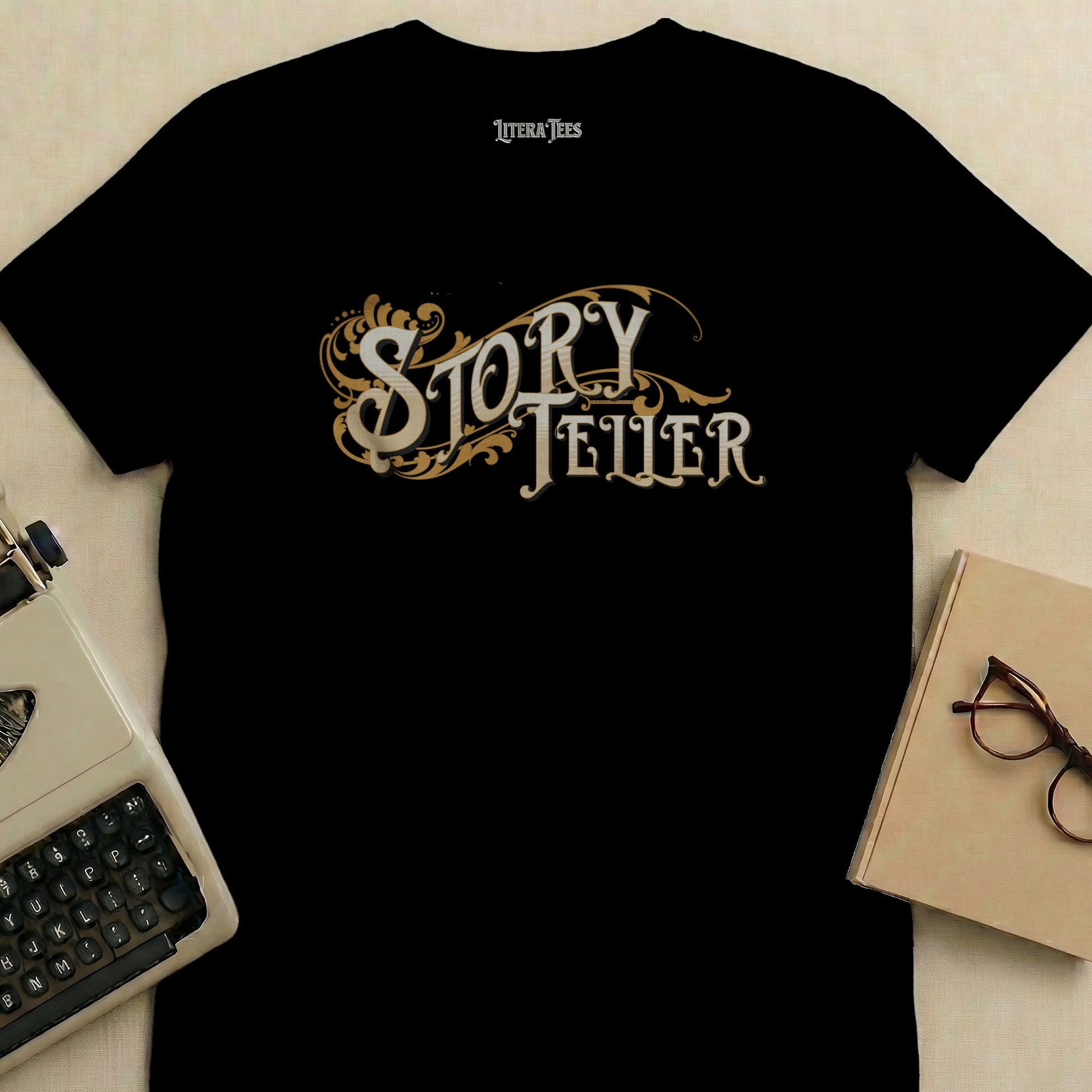 Black t-shirt with "Literatees Story Teller" text and ornate flourishes.