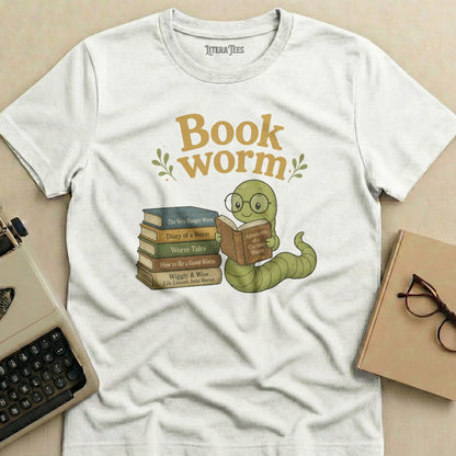 White t-shirt with "Book worm" text, illustrated worm reading, and stack of books.