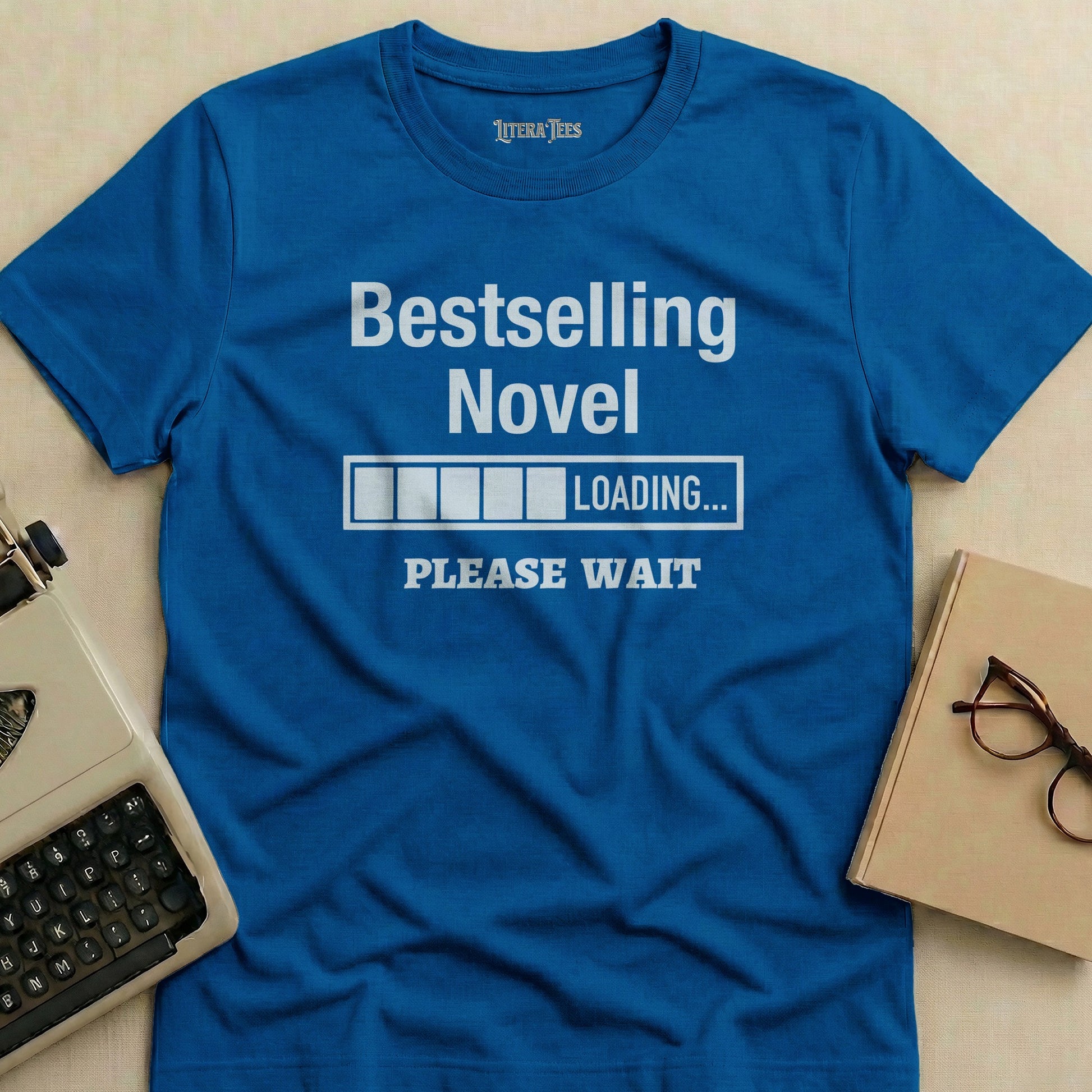 Blue t-shirt with "Bestselling Novel LOADING... PLEASE WAIT" text.
