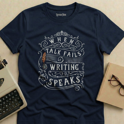 Navy t-shirt with "WHEN TALK FAILS WRITING SPEAKS" text and quill design.