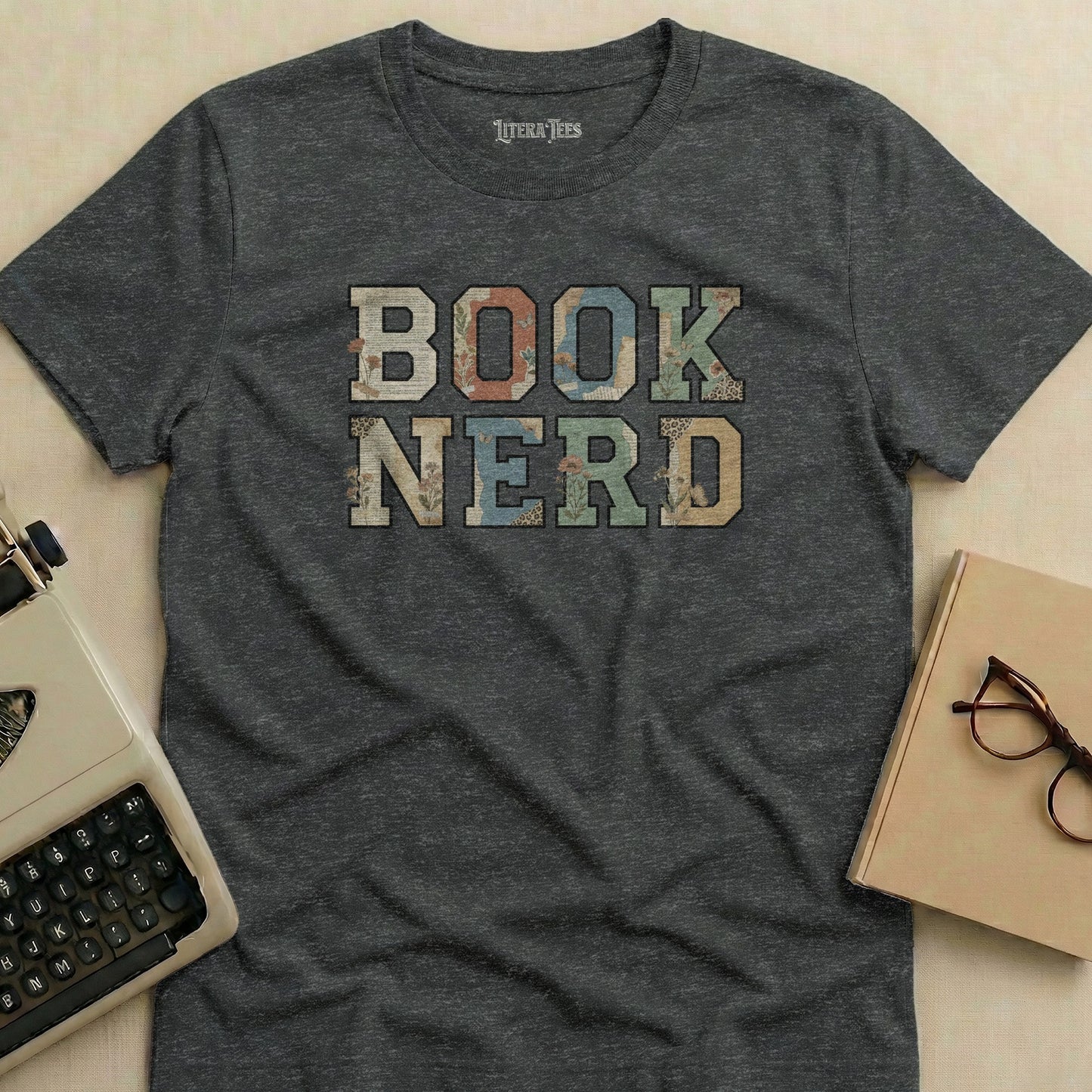 Dark t-shirt with "BOOK NERD" in textured, colorful block letters.