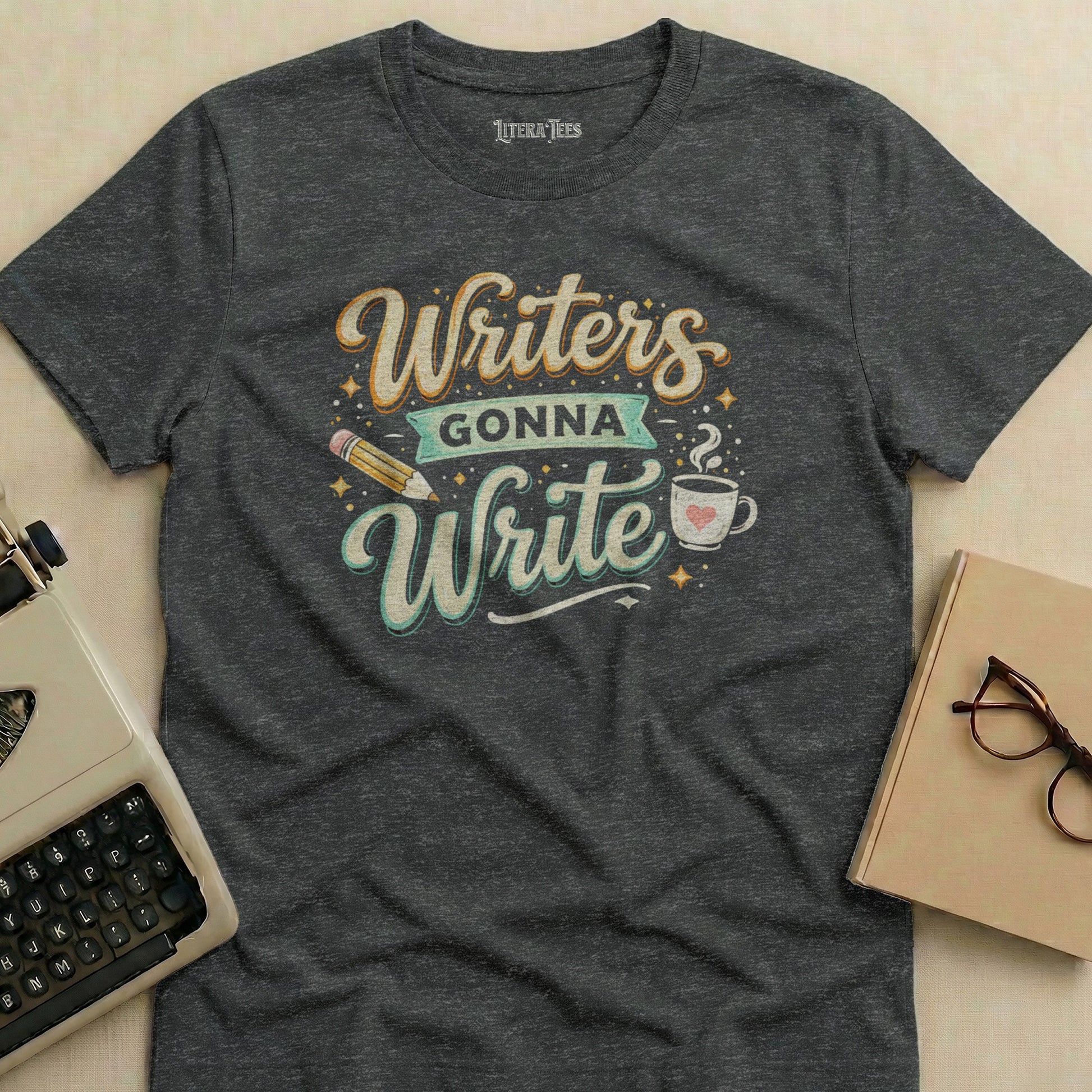 Dark gray t-shirt with "Writers Gonna Write" text, pencil, and coffee cup graphic.