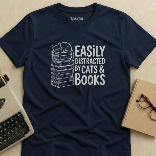 Navy t-shirt with white text and illustration of a cat on a stack of books.