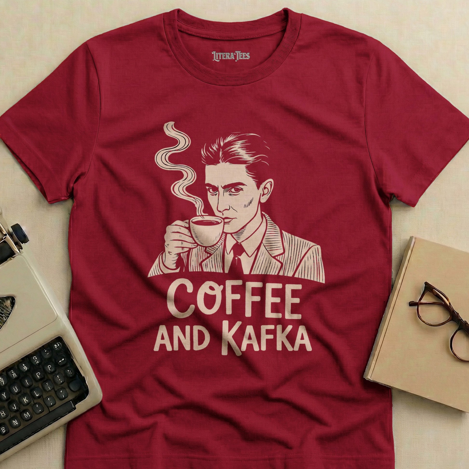 Maroon t-shirt with "Coffee and Kafka" text and a man holding a coffee cup.