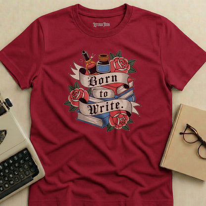Maroon t-shirt with "Born to Write." text, books, roses, and inkwell design.