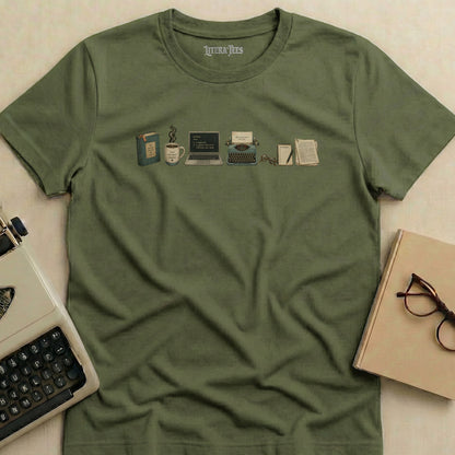 Green t-shirt with writer's tools graphic: book, coffee, laptop, typewriter, glasses, and notebooks.