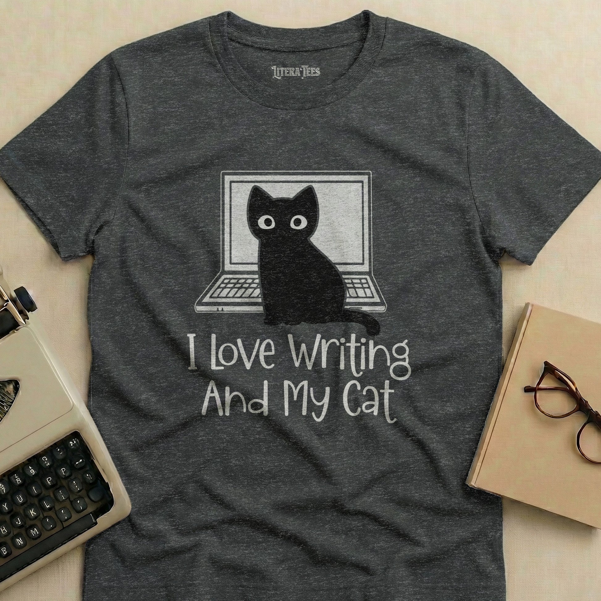 Dark gray t-shirt with white text "I Love Writing And My Cat" and a black cat on a laptop.