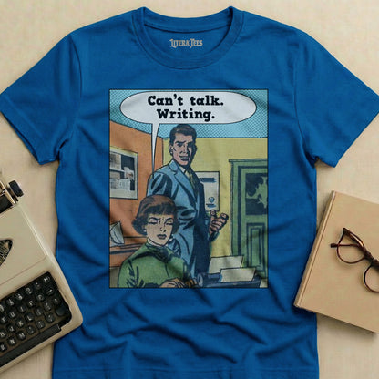 Blue t-shirt with "Can't talk. Writing." comic-style graphic.