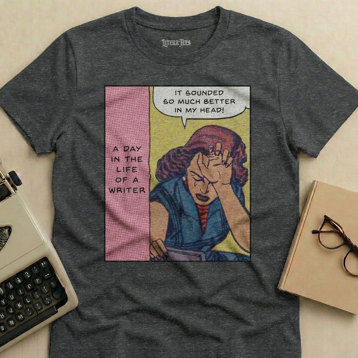T-shirt with comic-style graphic: A distressed woman with the text "A day in the life of a writer" and "It sounded so much better in my head!".
