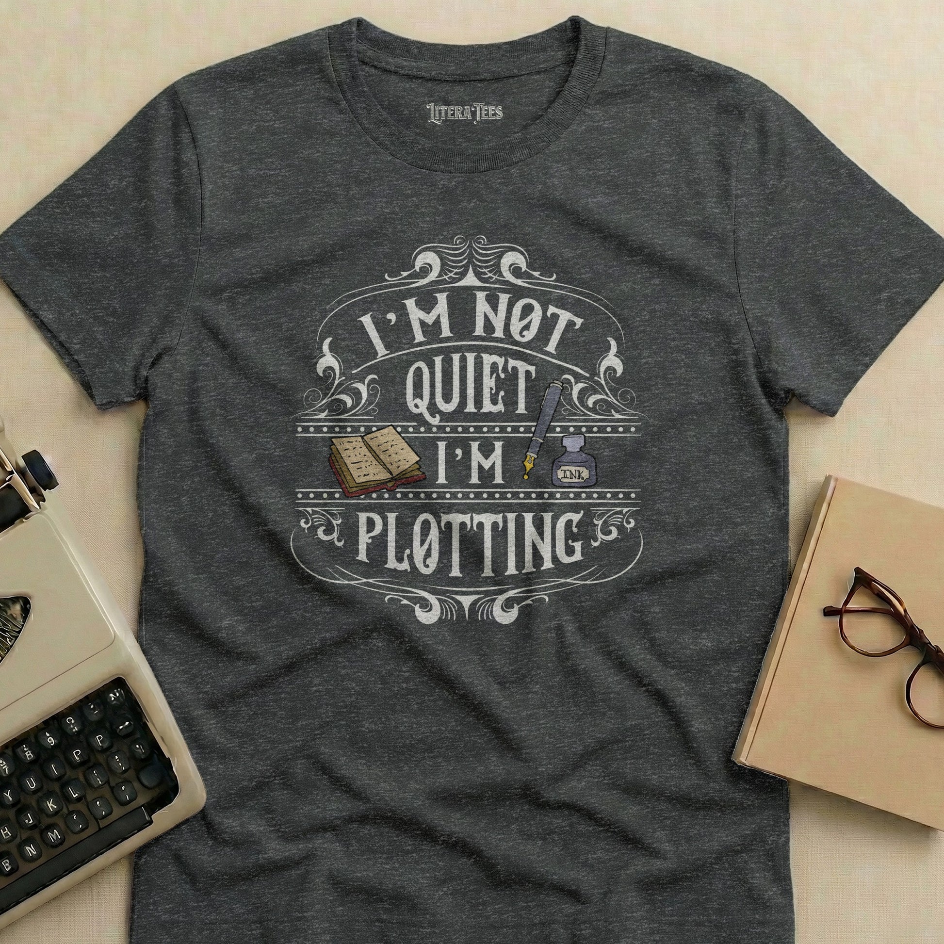 Dark grey t-shirt with "I'm not quiet I'm plotting" text design.
