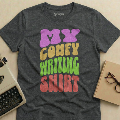Dark grey t-shirt with "My Comfy Writing Shirt" in colorful, wavy text.