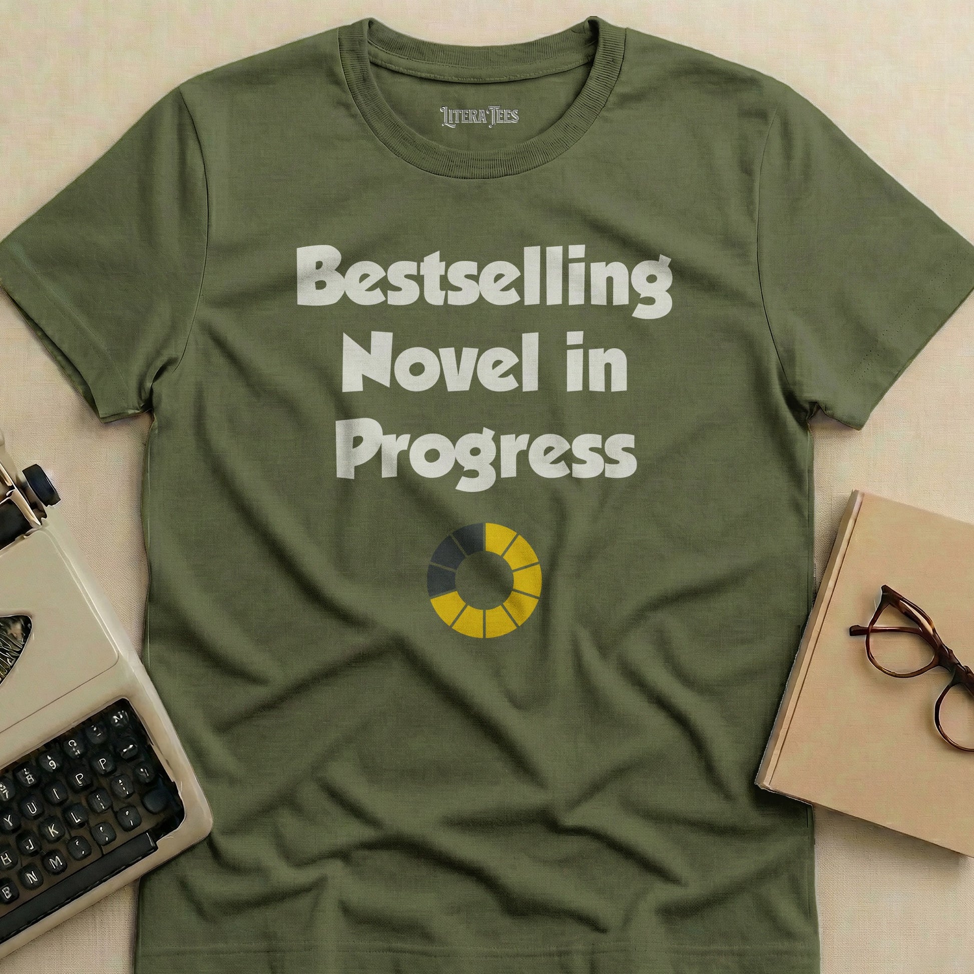 Olive t-shirt with "Bestselling Novel in Progress" and a loading bar.