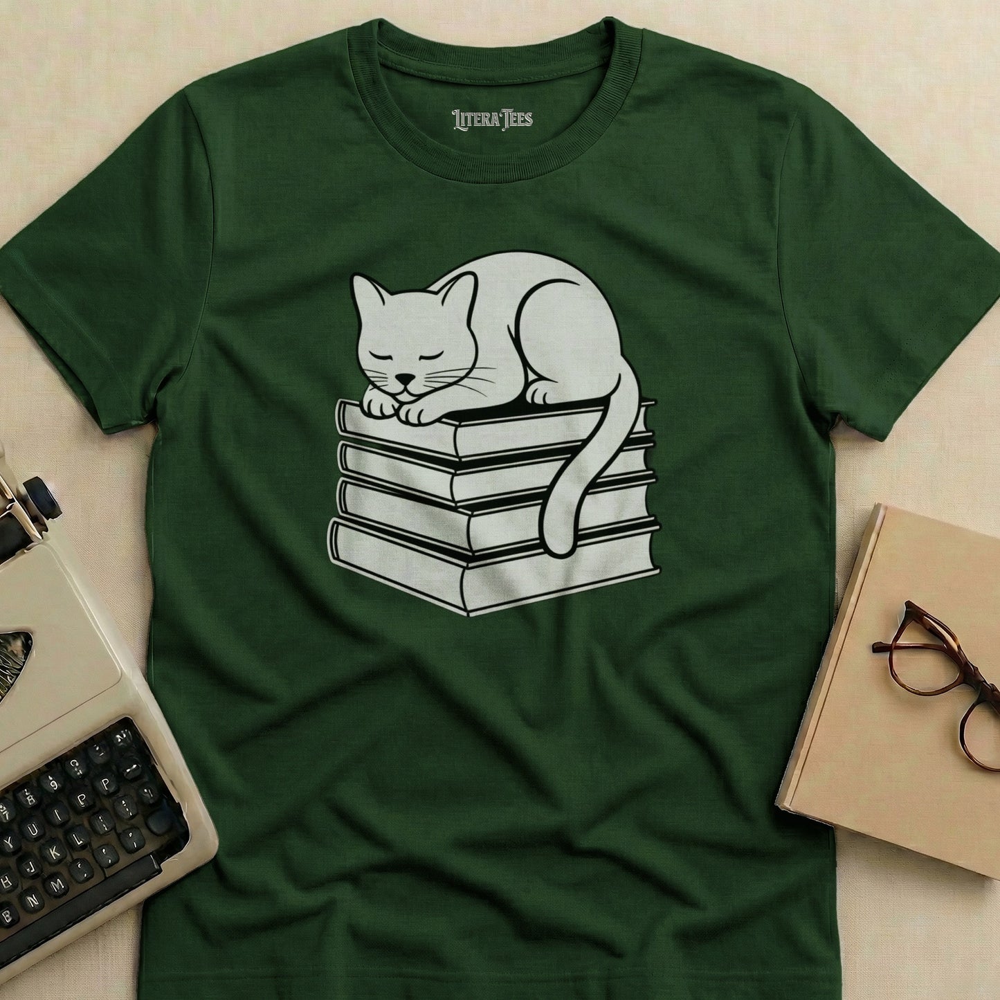 White cat sleeping on a stack of books, green t-shirt design.