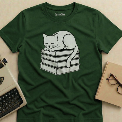 White cat sleeping on a stack of books, green t-shirt design.