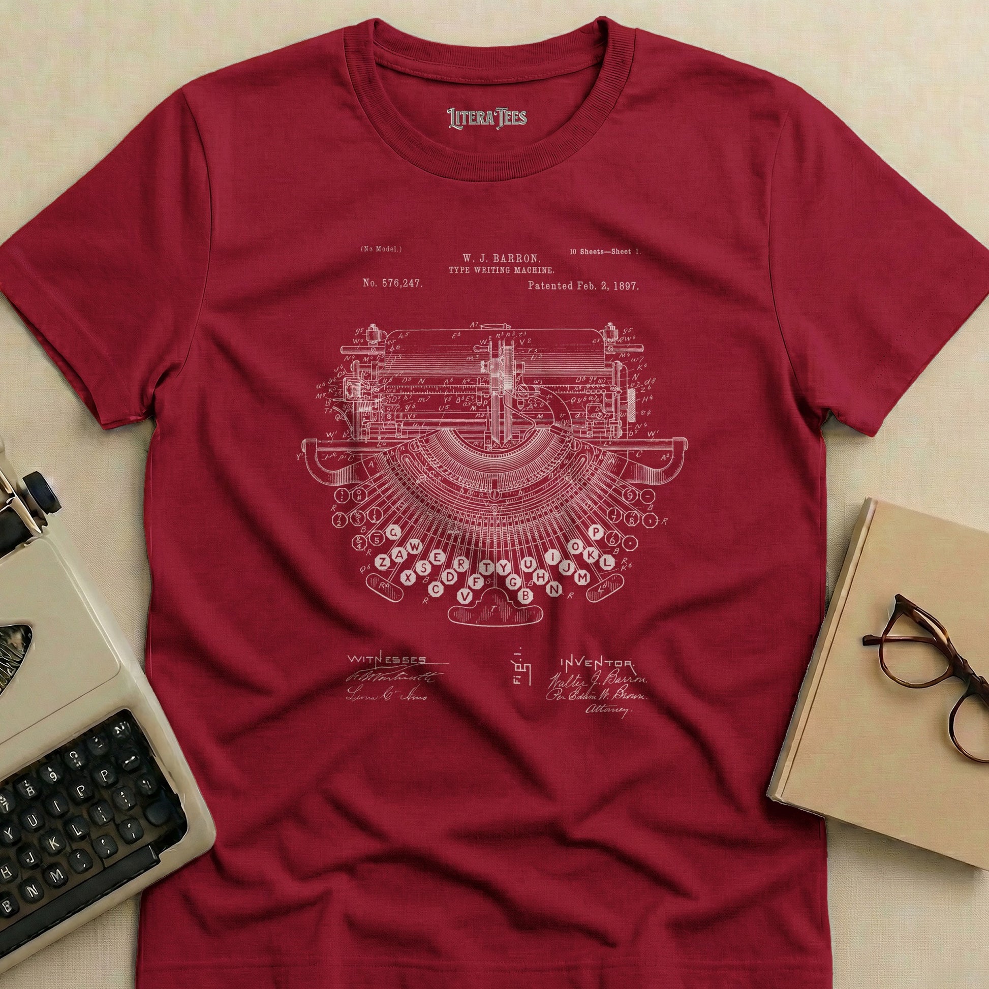 Maroon t-shirt featuring a patent drawing of a typewriter.
