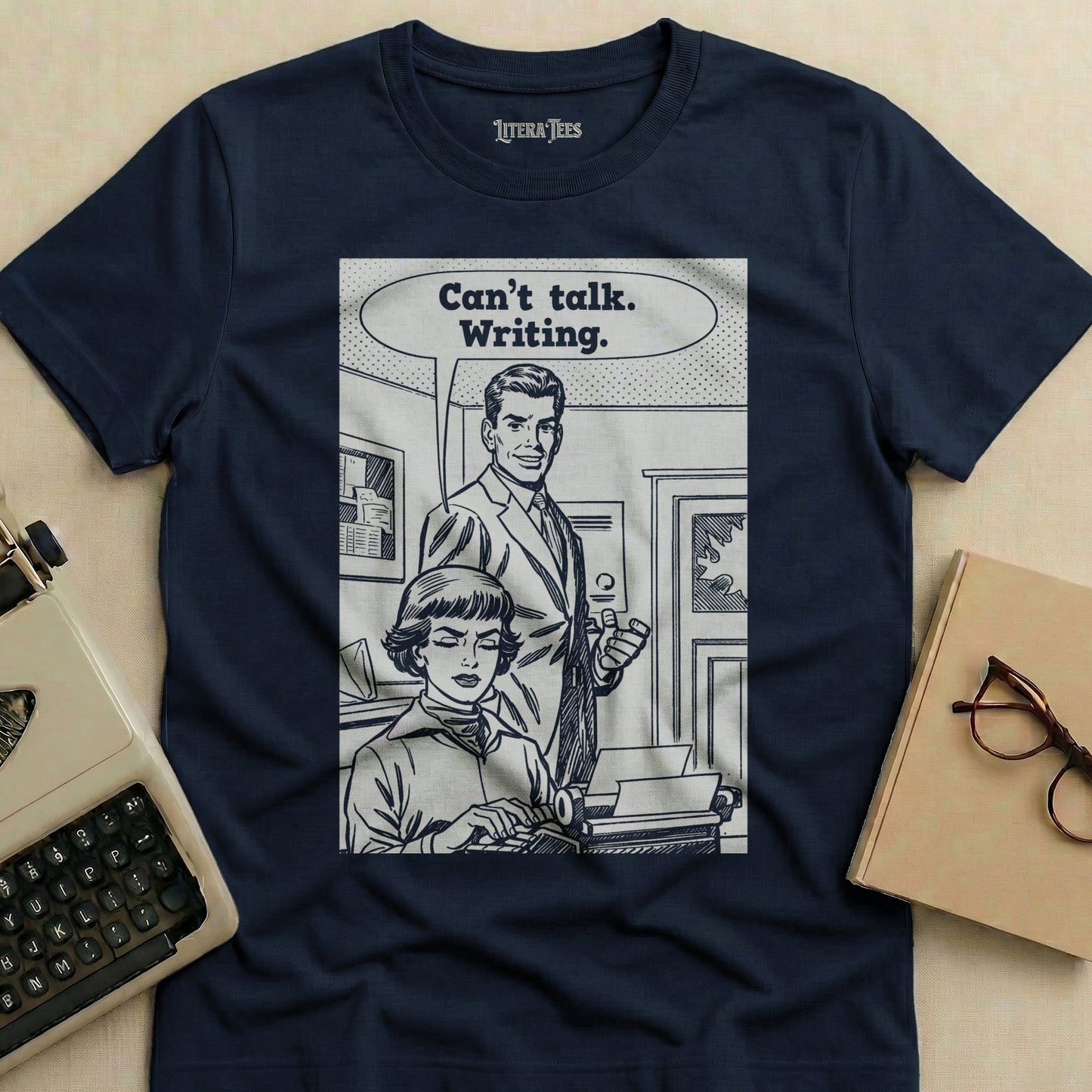 Navy t-shirt with comic panel featuring "Can't talk. Writing." text.